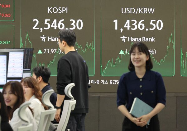 25일 서울 중구 하나은행 본점 딜링룸에서 딜러들이 대화하고 있다. /연합뉴스.
