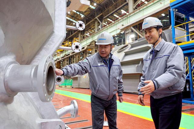 박정원 두산그룹 회장(왼쪽)이 지난 11일 경남 창원 두산에너빌리티 사업장을 방문해 제작 중인 발전용 가스터빈 제품을 살펴보고 있다./두산