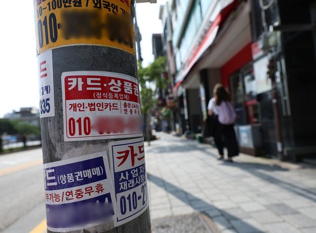 전봇대에&nbsp;신용카드 대납대출 광고스티커가 붙어있다. 사진/연합뉴스