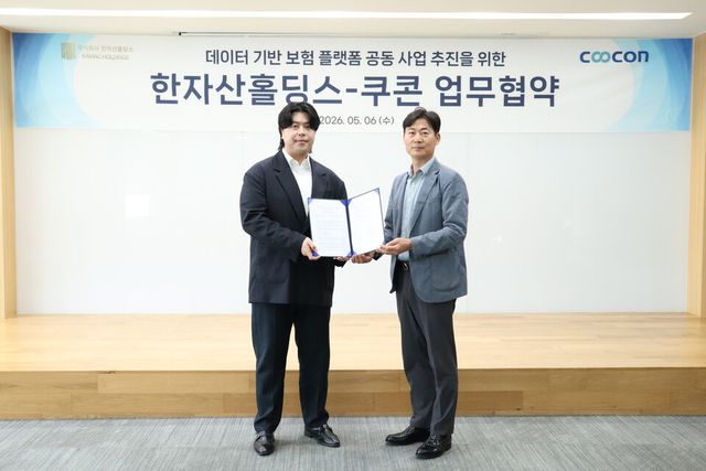 쿠콘 박성용(오른쪽) 부대표와 한자산홀딩스 홍유민 대표이사가 데이터 기반 보험 플랫폼 공동 사업 추진을 위한 업무협약을 체결한 후 기념 촬영을 하고 있다. /쿠콘