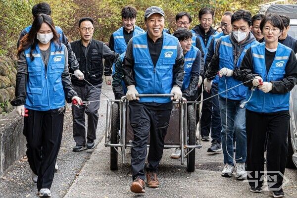 김문석 SBI저축은행 대표이사가 SBI희망나눔 봉사단원들과 함께 연탄을 배달하고 있다 [SBI저축은행]