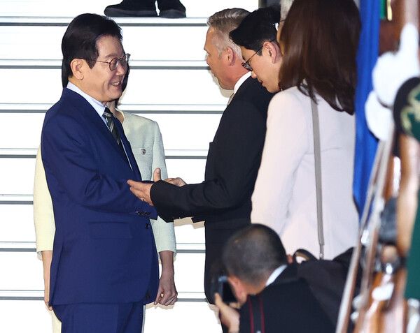 주요 20개국(G20) 정상회의에 참석하는 이재명 대통령이 21일(현지시간) 남아프리카공화국 요하네스버그 OR탐보국제공항에 도착한 뒤 영접인사와 인사를 나누고 있다. [연합뉴스]