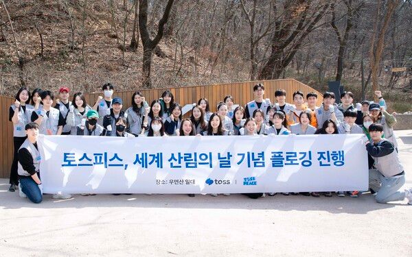 지난 14일 우면산 무장애숲길 입구, 토스피스 플로깅 활동에 참여한 토스 팀원들이 기념촬영을 하고 있다. [토스]