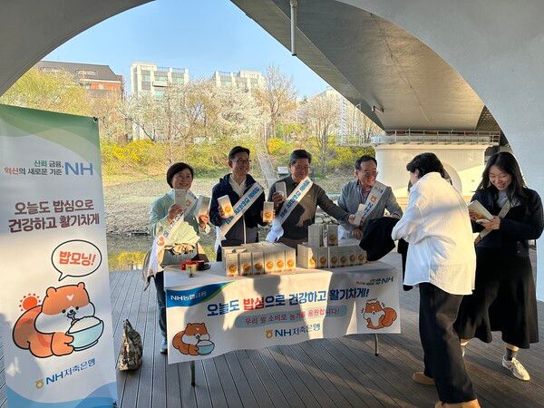 NH저축은행은 지난 11일 서초구 영동2교 하단에서 우리 쌀 나눔행사를 진행했다. 김장섭 NH저축은행 대표이사(왼쪽에서 네 번째)와 임직원들이 시민들에게 농협쌀을 나눠주고 있다. [NH농협금융]