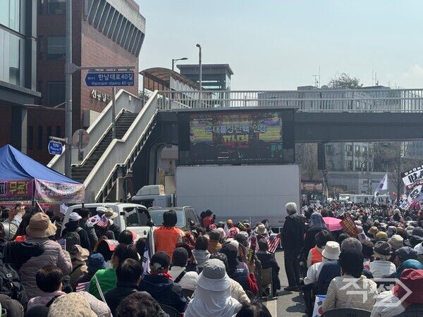 3일 서울 한강진역 이는 탄핵 반대 집회 시위 현장. 시위 현장에 설치된 모니터에 윤 전 대통령 파면 확정이 표시돼 있다. [손성은 기자]
