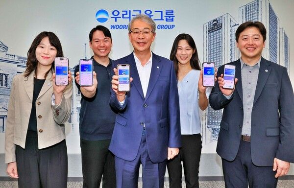 우리금융그룹 임종룡 회장(가운데)이 지난 6일 유니버설뱅킹 신규 가입자 100만명 돌파를 기념해 직원들과 사진을 촬영하고 있다. [우리금융그룹]