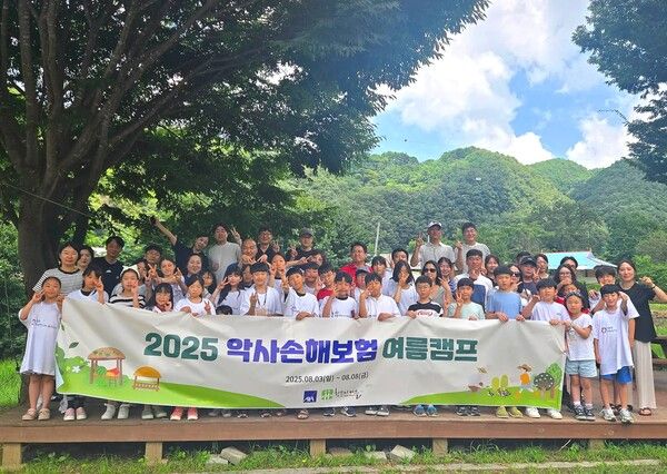충북 단양 한드미마을에서 진행된 여름 농촌캠프에서 AXA손해보험 임직원과 참가자녀들이 기념촬영을 하고 있다. [악사손보]
