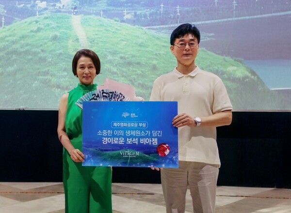 최필재 비아생명공학 대표이사(오른쪽) 가 배우 문희경에게 제주영화제 공로상을 시상하고 생체보석 ‘비아젬’ 부상과 함께 기념사진을 촬영하고 있다. [보람그룹]