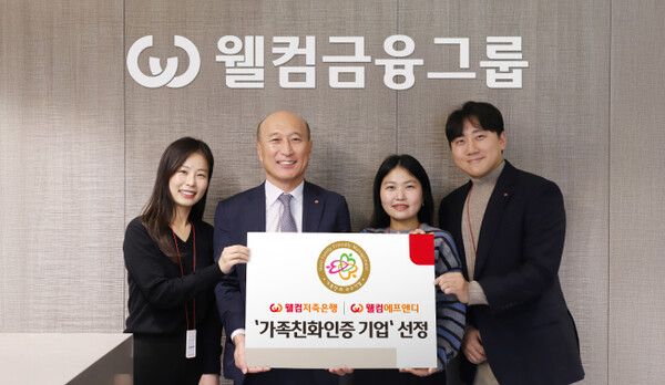 김대웅 웰컴저축은행 대표(왼쪽에서 두번째)와 다자녀·효도수당을 이용 중인 웰컴금융그룹&nbsp;직원들이 가족친화인증 획득을 기념하며 사진 촬영하고 있다. [웰컴금융그룹]