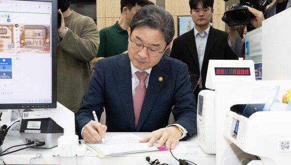 이억원 금융위원장이 22일 서울 종로구 NH농협은행 정부서울청사 지점에서 국민참여성장펀드에 가입하고 있다. [연합뉴스]