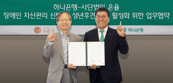 하나은행은 지난 15일 서울시 삼성동 소재 파르나스타워에서 사단법인 온율과 장애인 자산관리 신탁 및 성년후견 제도 활성화를 위한 업무협약을 체결했다. 이날 협약식에 참석한 윤세리 사단법인 온율 이사장(사진 왼쪽)과 김진우 하나은행 자산관리그룹 부행장이 기념 촬영을 하고 있다. [하나은행]
