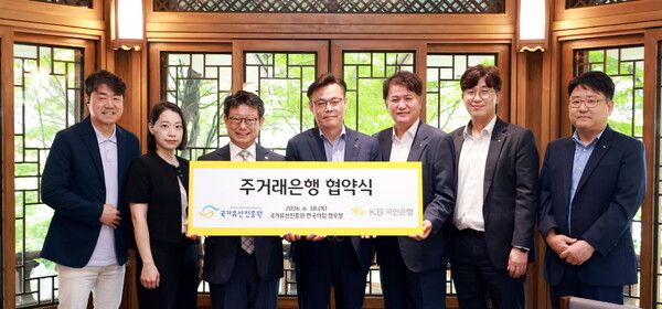 지난 18일 서울 중구‘ 한국의 집’에서 열린 주거래은행 협약식에 참여한 이귀영 국가유산진흥원장(왼쪽에서 3번째)과 김영일&nbsp;KB국민은행 기관영업그룹 부행장(왼쪽에서 4번째)을 비롯한 관계자들이 기념촬영을 하고 있다.