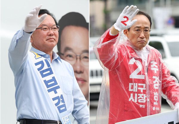 더불어민주당 김부겸 대구시장 후보(왼쪽)와 국민의힘 추경호 대구시장 후보가 2일 대구 중구 반월당사거리와 북구 복현오거리에서 각각 아침 인사를 하고 있다. [연합뉴스]