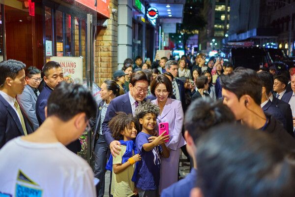 유엔총회 참석차 미국 뉴욕을 방문한 이재명 대통령 부부가 21일(현지시간) 코리아타운을 방문해 현지 어린이들과 기념촬영을 하고 있다. [연합뉴스]