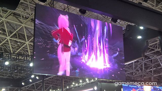 위에 걸려 있는 전광판에서는 메이츠(캐릭터)들의 궁극기 연출이 재생되고 있고 (사진: 게임메카 촬영)