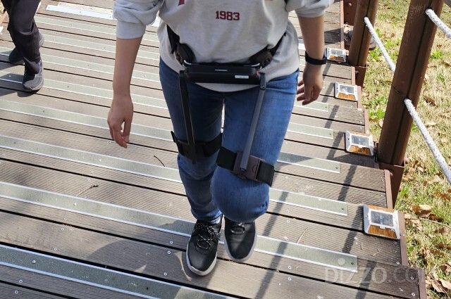 위로보틱스의 웨어러블 보행 로봇 ‘WIM S’를 착용하고 계단을 오르는 모습. /사진=김정아 기자