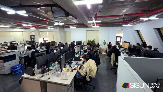Employees work at XCURENET’s headquarters