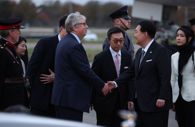 영국을 국빈 방문하는 윤석열 대통령과 부인 김건희 여사가 20일(현지 시각) 런던 스탠스테드 공항에 공군1호기편으로 도착해 환영나온 인사들과 악수하고 있다. [사진=연합뉴스]