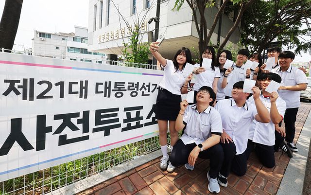 제21대 대통령선거 사전투표 첫날인 29일 경기도 수원시 장안구 연무동행정복지센터에 마련된 투표소에서 투표를 마친 삼일공업고등학교 3학년 학생들이 투표확인증을 들고 인증사진을 찍고 있다. [사진=연합뉴스]