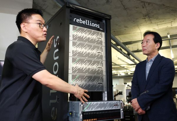 정태호 국정기획위원회 경제1분과장이 지난달 25일 경기도 성남시 분당구 AI 반도체 설계 스타트업 리벨리온을 방문, 박성현 리벨리온 대표로부터 리벨리온의 NPU 카드를 탑재해 실제 데이터센터에서 운용되는 서버 랙 구성의 설명을 듣고 있다. [사진=연합뉴스]