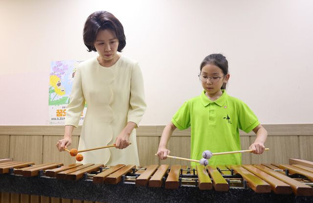 김혜경 여사가 29일 서울 구로아트밸리를 찾아 '꿈의 오케스트라'의 한 단원과 마림바를 함께 연주하고 있다. [사진=연합뉴스]