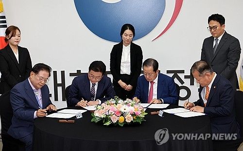 합의문에 서명하는 참석자