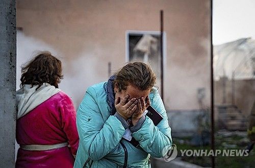 17일(현지시간) 러시아군의 미사일 공격으로 무너진 집을 보며 슬퍼하는 우크라이나 여인