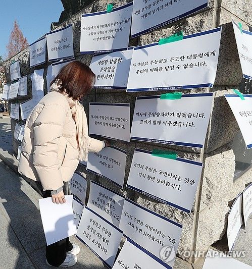 정권 규탄 피켓 붙이는 대학생