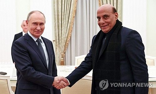 악수하는 푸틴 러시아 대통령(왼쪽)과 싱 인도 국방장관