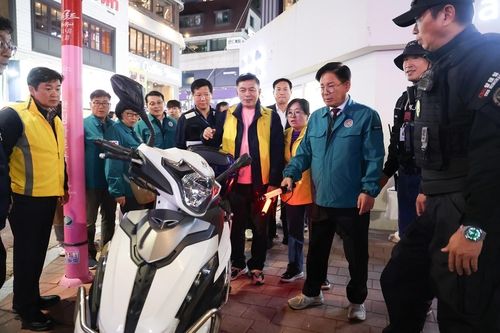 인도 위에 세워진 오토바이를 살펴보는 박강수 구청장