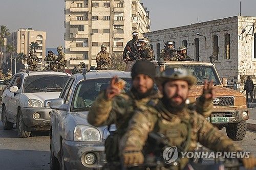 시리아 하마 시내를 행군하는 반군. [AP=연합뉴스]