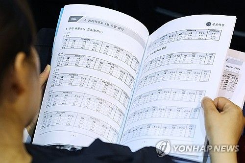 '자녀를 위해 꼼꼼하게 자료 살펴보는 학부모'