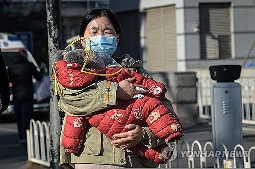 아이를 안고 병원에서 나온 베이징 시민