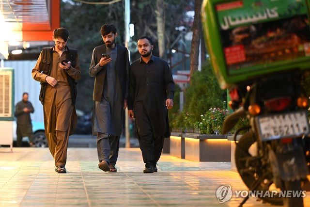 인터넷이 복원된 1일 휴대전화 보는 아프간 카불 시민들