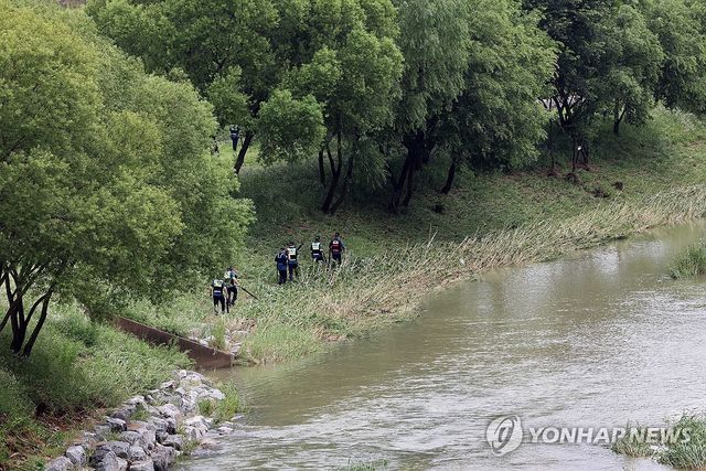 천변 실종자 수색작업 중인 경찰
