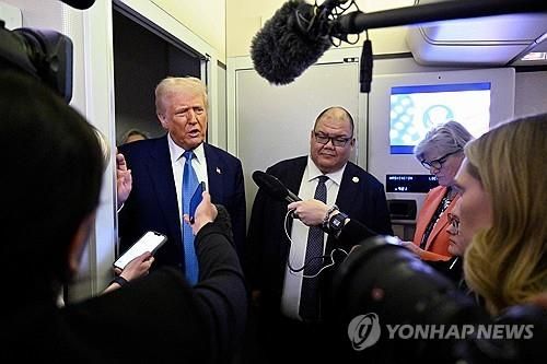 대통령 전용기 안에서 기자 질문에 답하는 트럼프