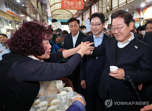 사천읍시장 상인과 인사하는 이재명 후보