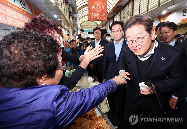 사천읍시장 상인과 인사하는 이재명 후보