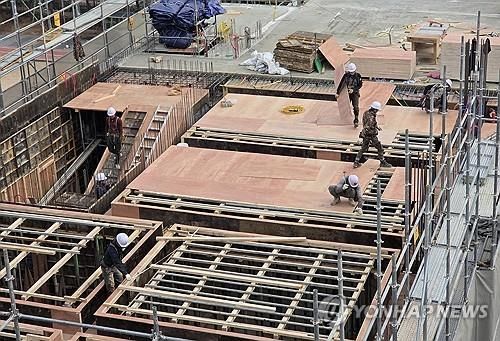 서울의 한 건설현장에서 작업자들이 자재를 옮기고 있다.