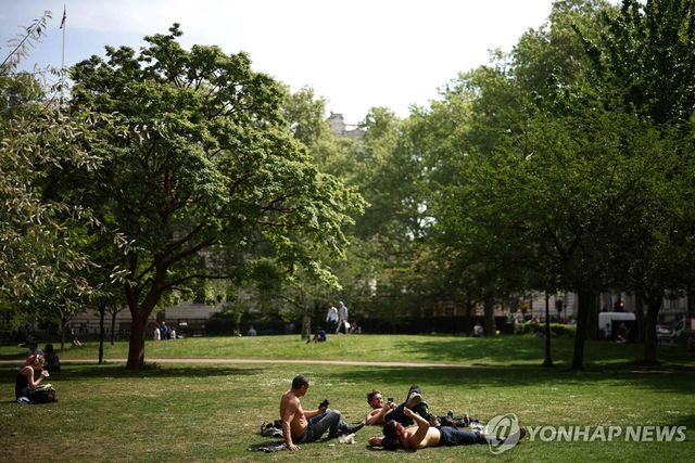 5월 초 런던 공원에서 햇볕 즐기는 사람들