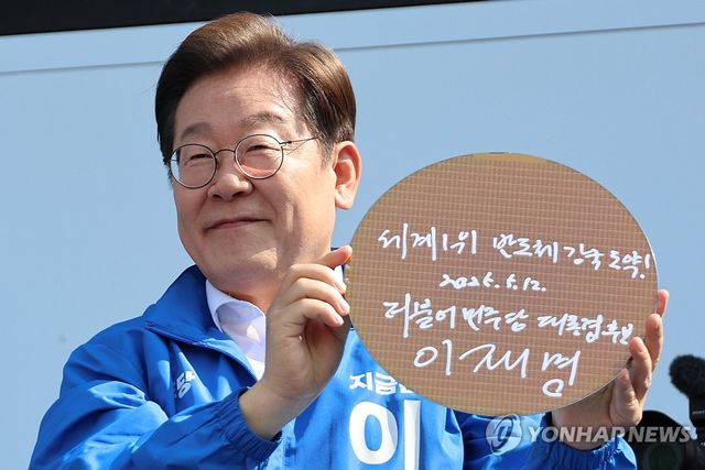 이재명 대통령 당선인 6·3 대통령선거 공식 선거운동 첫날인 지난 5월 12일 경기 화성시 동탄 센트럴파크 음악분수중앙광장 유세장에서 '세계1위 반도체 강국 도약!'이라고 쓰고 서명한 반도체 웨이퍼를 들어보이고 있다.[연합뉴스 자료사진]