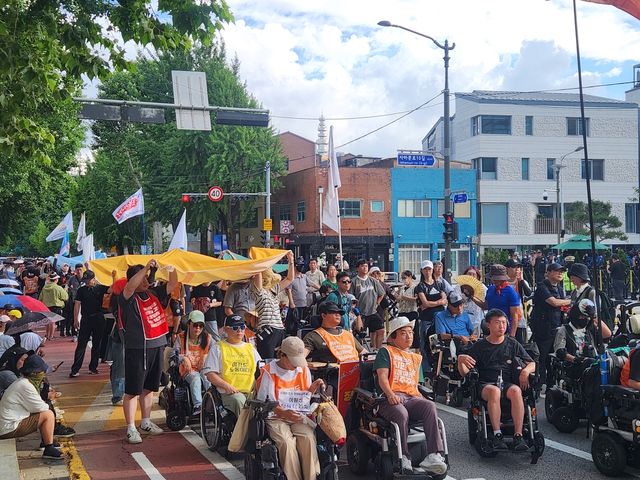 국정기획위원회 앞 행진 중인 전국장애인차별철폐연대 결의대회 참가자들