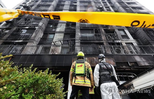 아파트 화재 현장 살펴보는 관계자들