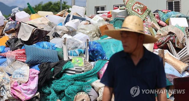 마을 입구에 쌓여 있는 침수 피해 쓰레기들
