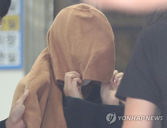 얼굴 가린 뉴질랜드 '가방 속 아이 시신' 용의자