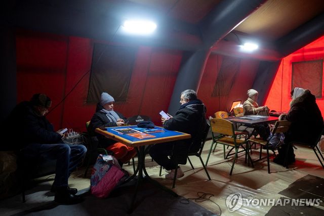 비상텐트에서 몸을 녹이는 우크라 시민들