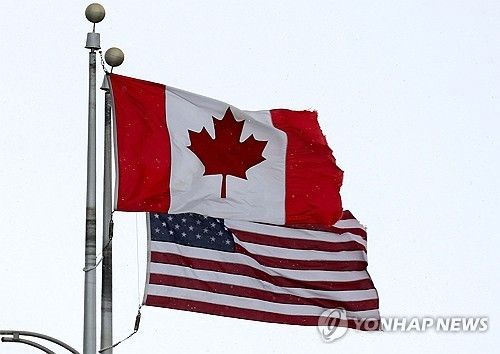 국경을 가르는 나이아가라 폭포의 캐나다 영토에 걸린 캐나다와 미국 국기