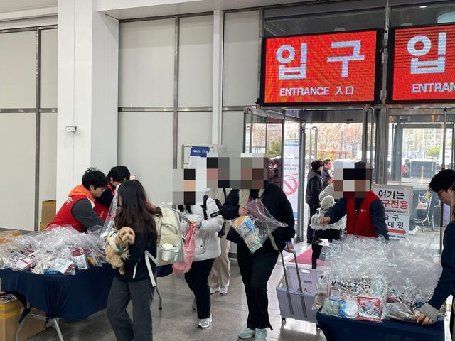 사료와 간식 등 선착순 선물을 받아 가는 사람들