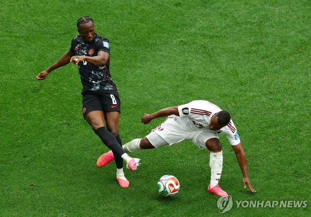 카타르 마디보(오른쪽)가 캐나다 코네에게 반칙을 범하는 모습.