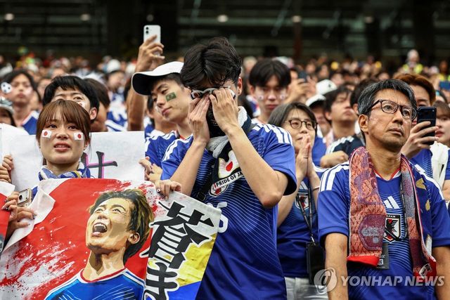 눈물을 닦는 일본 축구 대표팀 팬들